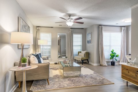 a living room with a couch and a ceiling fan